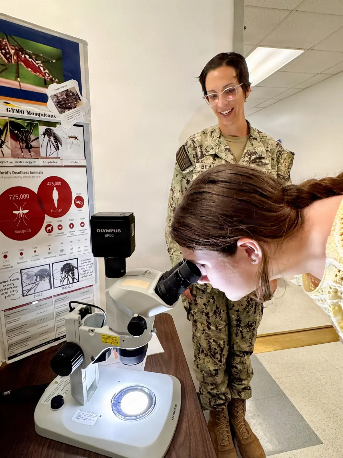 A student looking through a microscope during a health careers learning activity